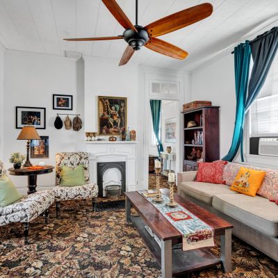 Warm living room w/ eclectic charm flowing into the outdoor space.
