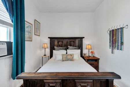 Warm guest bedroom w/ timeless style & inviting comfort.
