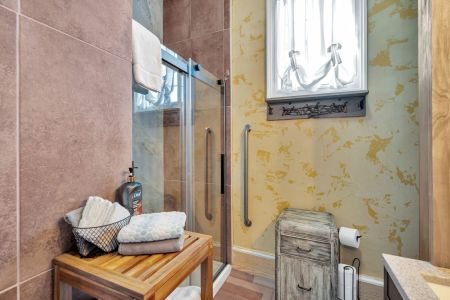 Sun-soaked bathroom w/ warm tones & a refreshing shower.

